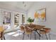 Sunlit dining area featuring a modern table, stylish chairs, and access to the outdoor deck at 10729 Trego Trl, Raleigh, NC 27614