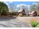 Inviting exterior showcasing a beautiful home with a circular driveway and lush landscaping at 10729 Trego Trl, Raleigh, NC 27614