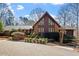 Lovely home with stone and wood exterior, showcasing a well-manicured front yard at 10729 Trego Trl, Raleigh, NC 27614