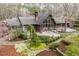 Beautifully landscaped home with a wraparound deck and lush greenery at 10729 Trego Trl, Raleigh, NC 27614