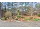 Circular driveway and professionally landscaped front yard with mature trees and plantings at 10729 Trego Trl, Raleigh, NC 27614