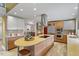 Spacious kitchen featuring light-colored cabinets, stainless steel appliances, an island, and hardwood floors at 10729 Trego Trl, Raleigh, NC 27614