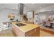 Contemporary kitchen with a stainless steel range hood, breakfast bar, hardwood floors, and a dining area at 10729 Trego Trl, Raleigh, NC 27614