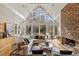 Bright living room boasting a stone fireplace, floor-to-ceiling windows, and hardwood floors at 10729 Trego Trl, Raleigh, NC 27614