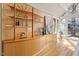 Open living space featuring custom built-ins, hardwood floors, and a view of the outdoors through large windows at 10729 Trego Trl, Raleigh, NC 27614