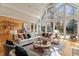 Sunlit living room with a vaulted ceiling, large windows, and hardwood floors, creating a bright and airy space at 10729 Trego Trl, Raleigh, NC 27614