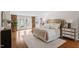 Comfortable main bedroom with a plush bed, hardwood floors, and french doors leading to a balcony at 10729 Trego Trl, Raleigh, NC 27614