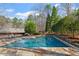 In-ground pool with stone accents offers a private oasis for relaxation and outdoor fun at 10729 Trego Trl, Raleigh, NC 27614