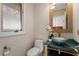 Stylish powder room featuring a unique vessel sink and designer mirror at 10729 Trego Trl, Raleigh, NC 27614