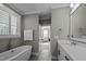 Bright bathroom features a soaking tub under the window and a double sink vanity at 110 Jacoby Way, Chapel Hill, NC 27516