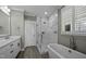 Bright bathroom features a soaking tub under the window and a tiled walk-in shower at 110 Jacoby Way, Chapel Hill, NC 27516
