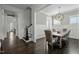 Elegant dining room with wainscoting, stylish chandelier, and dark hardwood floors at 110 Jacoby Way, Chapel Hill, NC 27516