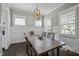 Bright dining room featuring wainscoting, wood floors, and an elegant light fixture at 110 Jacoby Way, Chapel Hill, NC 27516