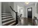 Inviting entryway with hardwood floors, staircase, and view into the dining room, offering a warm welcome at 110 Jacoby Way, Chapel Hill, NC 27516