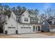 Charming two-story white home with a welcoming porch and a three car garage at 110 Jacoby Way, Chapel Hill, NC 27516
