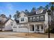 Beautiful two-story white home with a three car garage and well-manicured yard at 110 Jacoby Way, Chapel Hill, NC 27516