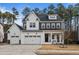 Stunning two-story home with a three car garage and crisp white exterior at 110 Jacoby Way, Chapel Hill, NC 27516
