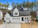 Charming two-story home boasts a three-car garage, gray roof, and landscaped front yard at 110 Jacoby Way, Chapel Hill, NC 27516