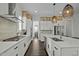 Bright kitchen featuring white cabinets, quartz countertops, stainless steel appliances, and a large island at 110 Jacoby Way, Chapel Hill, NC 27516