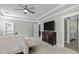 Comfortable main bedroom with a large bed, TV, and a doorway to an en-suite bathroom for added convenience at 110 Jacoby Way, Chapel Hill, NC 27516