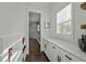 Pantry with white cabinets, quartz countertops, and a window providing natural light at 110 Jacoby Way, Chapel Hill, NC 27516