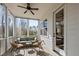 Charming screened-in porch featuring comfortable outdoor furniture, ceiling fan, and a serene view of the backyard at 110 Jacoby Way, Chapel Hill, NC 27516