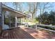 Outdoor deck leads to a screened-in porch and a view of the large, green backyard at 112 Celeste Cir, Chapel Hill, NC 27517