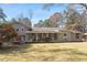Expansive backyard view featuring screened-in porch, large yard, and mature trees at 112 Celeste Cir, Chapel Hill, NC 27517