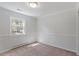 Cozy bedroom featuring neutral walls, carpet, and bright window at 112 Celeste Cir, Chapel Hill, NC 27517