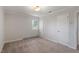 Bedroom with doors, neutral paint and carpet and a view out the window at 112 Celeste Cir, Chapel Hill, NC 27517