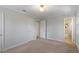 Bedroom with closet, neutral paint, and doorway leading to the bathroom at 112 Celeste Cir, Chapel Hill, NC 27517