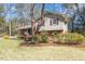 Charming exterior with brick and siding, complemented by lush greenery and mature trees at 112 Celeste Cir, Chapel Hill, NC 27517