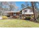 Charming home with brick and siding, landscaped front yard, and a covered carport at 112 Celeste Cir, Chapel Hill, NC 27517