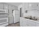 Charming eat-in kitchen featuring white appliances, cabinetry and tile backsplash at 112 Celeste Cir, Chapel Hill, NC 27517