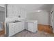 Classic eat-in kitchen with white cabinetry, a dishwasher and modern countertop at 112 Celeste Cir, Chapel Hill, NC 27517