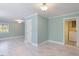 Sunny living room with tile flooring, modern lighting, and doorways to laundry at 112 Celeste Cir, Chapel Hill, NC 27517