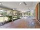 Bright sunroom with brick floors and walls of windows offering natural light and backyard views at 112 Celeste Cir, Chapel Hill, NC 27517