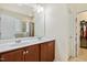 Bathroom featuring a double sink vanity with a marble countertop, mirror, and modern lighting fixtures at 117 Oak Rise Ln, Fuquay Varina, NC 27526