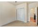 Empty bedroom featuring neutral walls, carpeted floors, and a closet, ready for personalization at 117 Oak Rise Ln, Fuquay Varina, NC 27526