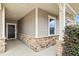 Inviting front porch features stone accents, neutral siding and a dark front door at 117 Oak Rise Ln, Fuquay Varina, NC 27526