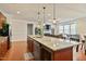Kitchen with granite countertops and stainless appliances opens to living room at 117 Oak Rise Ln, Fuquay Varina, NC 27526