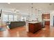 Open concept kitchen and living area featuring granite countertops and wood floors at 117 Oak Rise Ln, Fuquay Varina, NC 27526