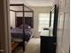 Bedroom featuring a four-poster bed, a dark dresser, and neutral carpeting at 12 Patriot Cir, Durham, NC 27704
