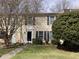 Charming townhouse featuring black shutters, manicured landscaping and a lush, green lawn at 12 Patriot Cir, Durham, NC 27704