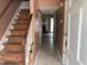 Hallway with stairs and view of the living room featuring a fireplace at 12 Patriot Cir, Durham, NC 27704