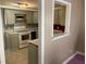 Kitchen with gray cabinets, white appliances, and a pass-through window at 12 Patriot Cir, Durham, NC 27704