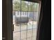 View of patio with grill and partial fence through a glass sliding door at 12 Patriot Cir, Durham, NC 27704