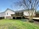 A spacious backyard with deck, grassy area, mature trees, and a partially fenced yard at 1213 Cotten Farm Dr, Fuquay Varina, NC 27526