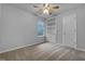 This bedroom features a ceiling fan, a window letting in natural light, and built-in shelves at 1213 Cotten Farm Dr, Fuquay Varina, NC 27526