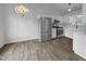 Bright kitchen featuring stainless steel appliances, white cabinets, and wood-look floors at 1213 Cotten Farm Dr, Fuquay Varina, NC 27526